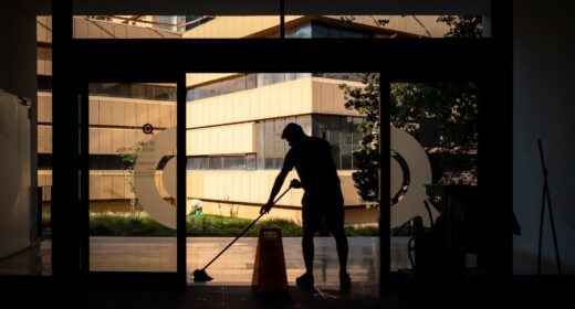 silhouette of man standing near glass window during daytime